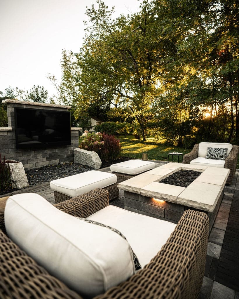 Outdoor entertainment area with stone fire pit and tv in Rocky River, Ohio