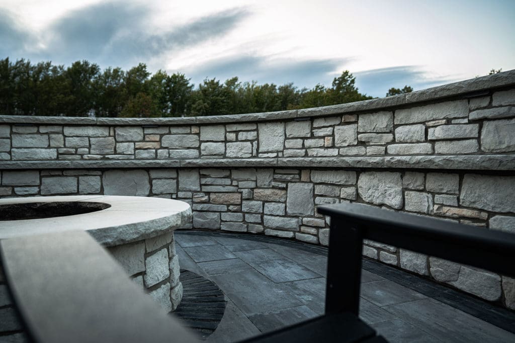 Stone patio with custom fire pit and entertaining area in Westlake, Ohio