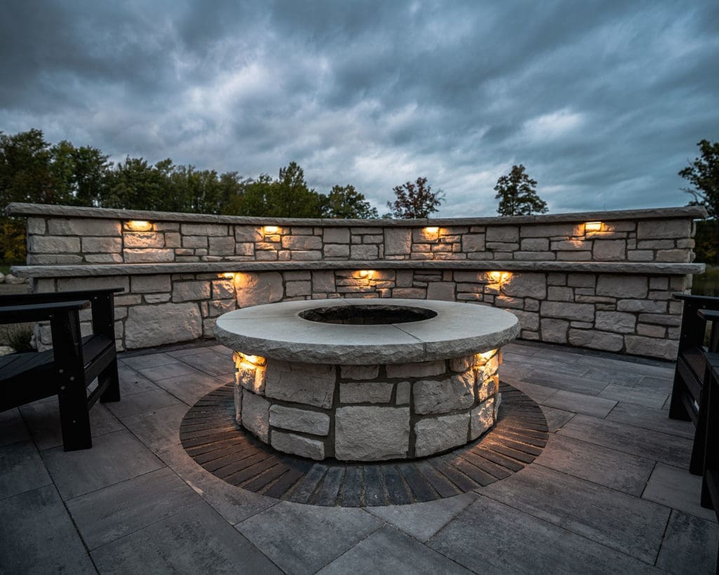 Stone patio with custom fire pit and entertaining area in Westlake, Ohio