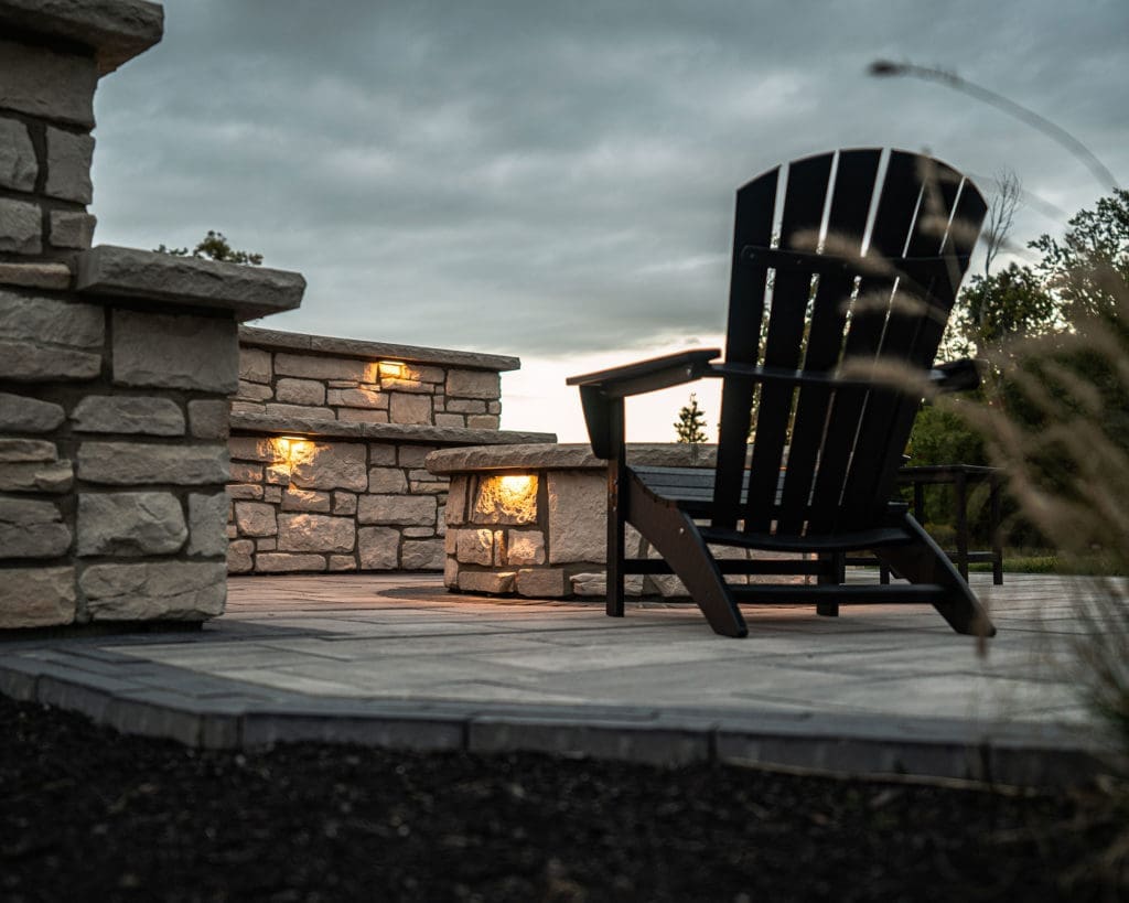 Stone patio with custom fire pit and entertaining area in Westlake, Ohio