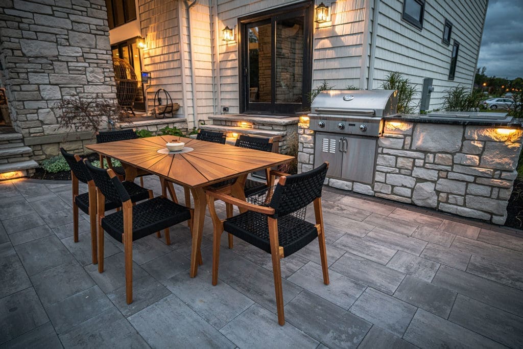 Beautiful, custom outdoor dining area with grill and dinner seating